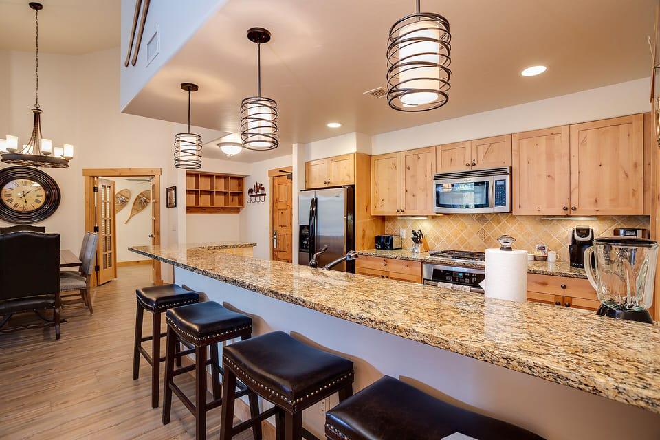 Your gourmet kitchen invites culinary adventures with granite counters, premium appliances, and a breakfast bar perfect for morning coffee conversations.