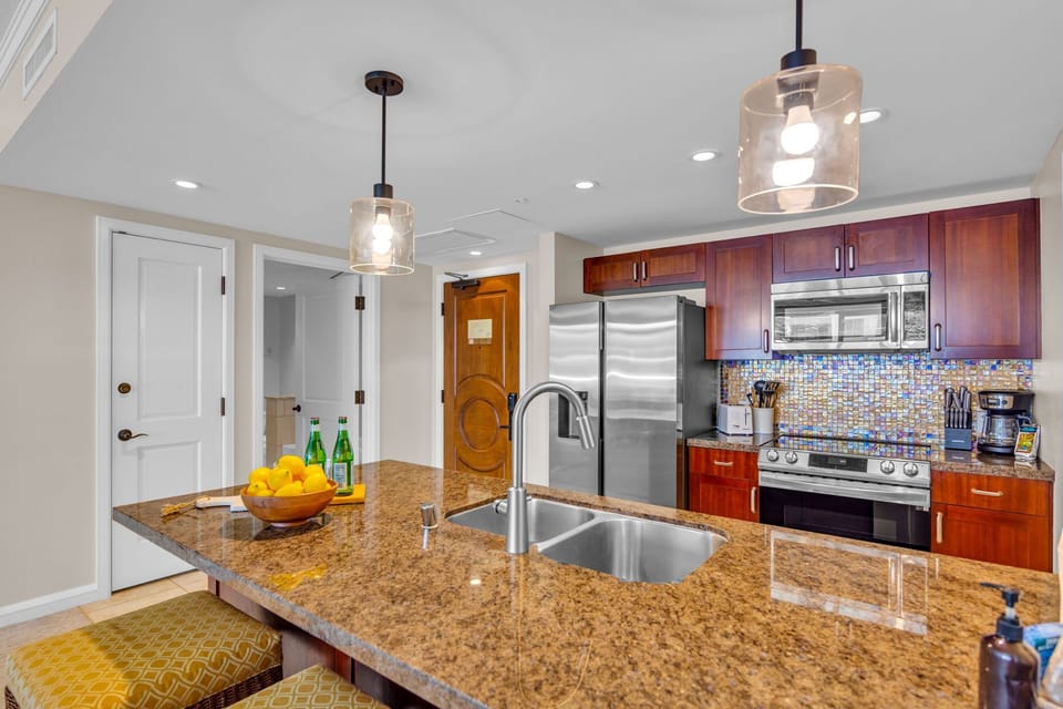 A fully equipped kitchen with stainless steel appliances makes home cooking a breeze