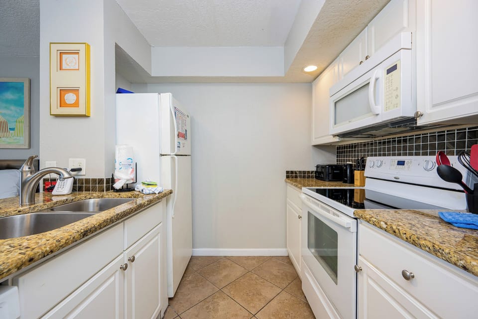 Kitchen featuring granite countertops and a convenient design for a delightful cooking experience