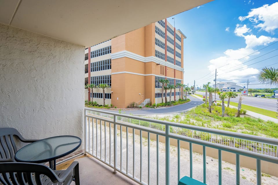 Enjoy a relaxing moment on the balcony, overlooking palm trees and a scenic view of the surrounding area
