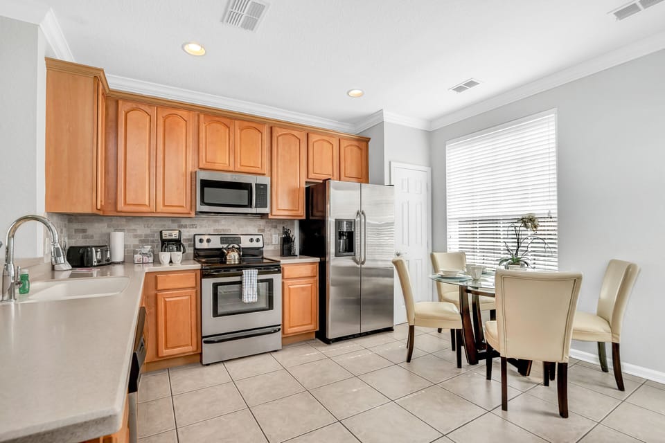 The Heart of the Home: This townhouse features an open-concept kitchen seamlessly connected to the dining area, making it effortless to serve and enjoy your meals.