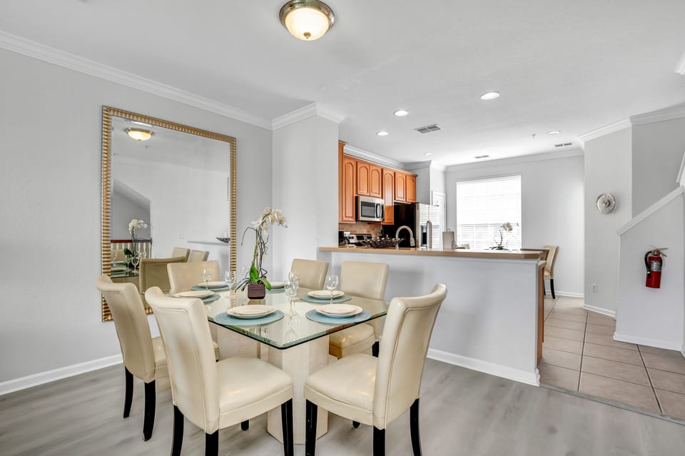 Gather around this cozy dining table for four, perfect for enjoying meals together in the comfort of your townhouse retreat.