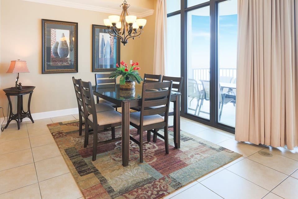 Gather around the sleek dining table to create cherished memories with family while enjoying coastal views
