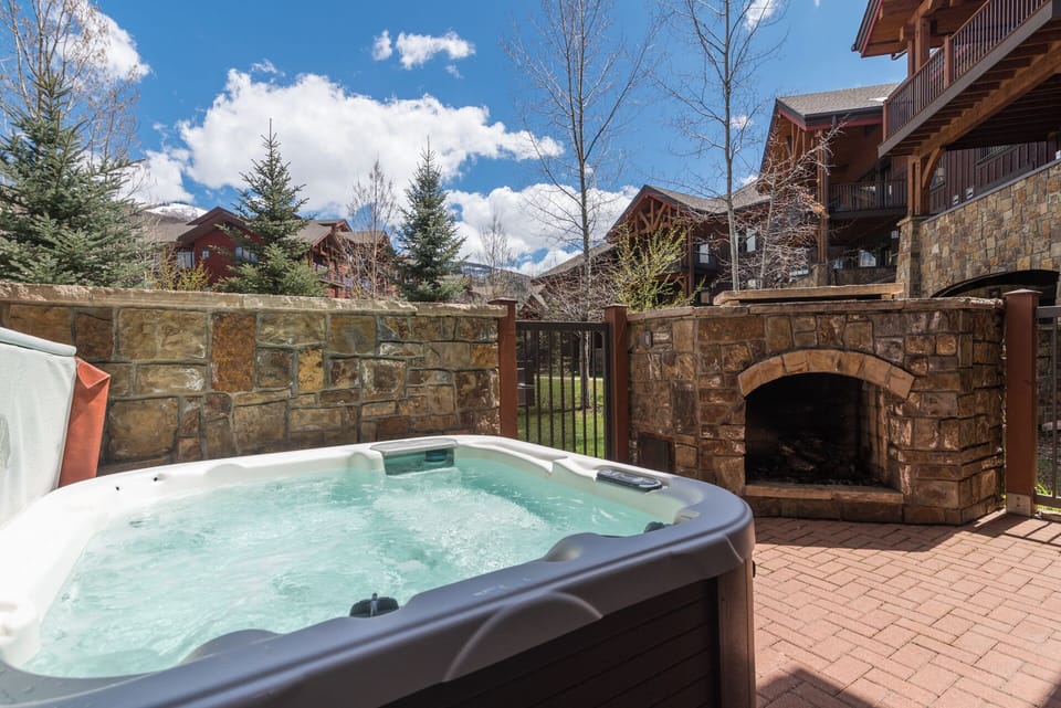Soak in your private hot tub while enjoying mountain views and cozy fireplace warmth.