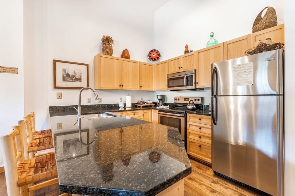 Your gourmet kitchen features granite countertops, stainless steel appliances, and warm wood cabinets—perfect for preparing memorable meals during your stay.