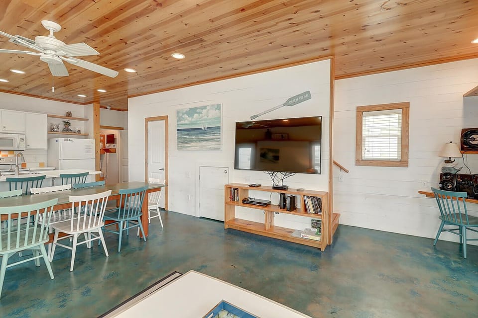 Relax in this bright coastal cottage with polished floors, warm wood ceilings, and charming nautical touches perfect for your beach getaway.