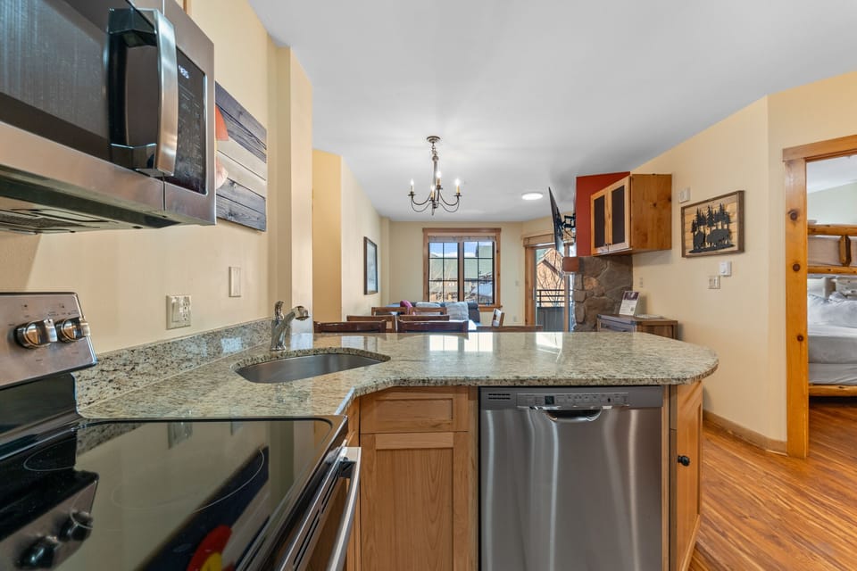 Your fully equipped kitchen features granite counters, stainless appliances, and an open layout perfect for preparing meals and connecting with loved ones.