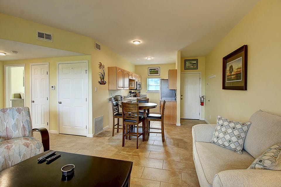 Your open-concept living space flows seamlessly from cozy seating to dining and fully-equipped kitchen, perfect for gathering and creating memorable moments together.