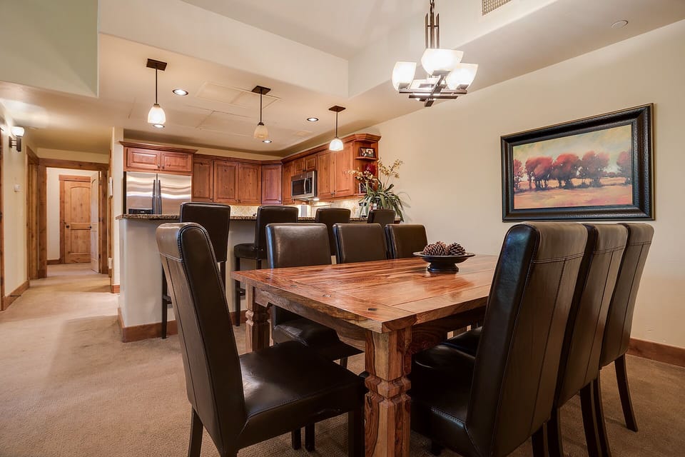 Gather around your elegant dining table for memorable meals, with rich wood finishes and a fully-equipped kitchen ready for your culinary adventures.