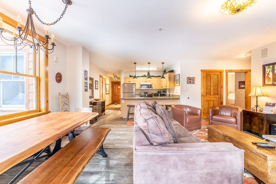 Relax in your spacious open-concept living area where warm wood accents and comfortable seating create the perfect mountain retreat atmosphere.