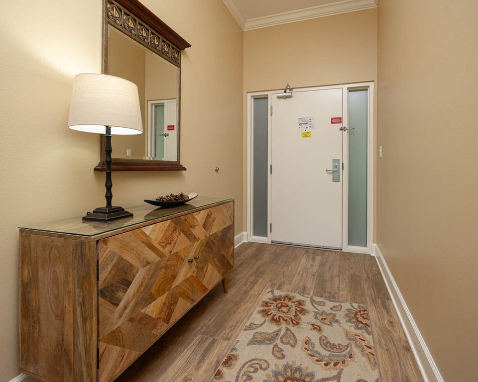 Step into this welcoming entryway, where the stylish decor sets the tone for your memorable coastal retreat