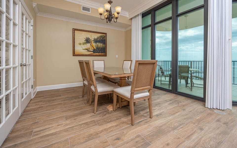 Gather your family around the stylish dining table, enjoying the stunning views beyond the tall windows