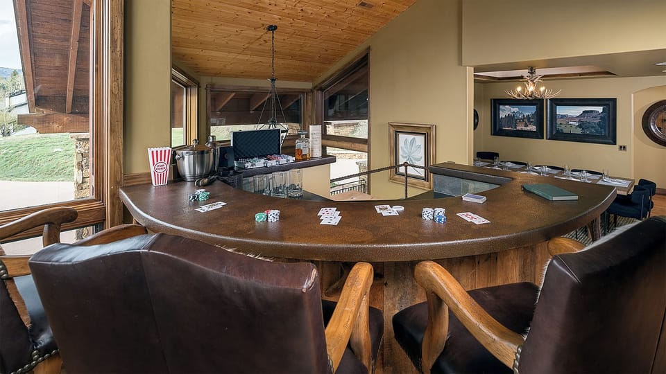 Deal yourself in at your private game table, where poker nights come alive beneath rustic beams and mountain views, with a full bar setup just steps away.
