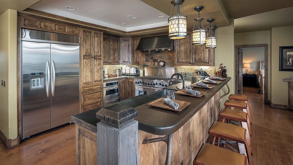 Your gourmet kitchen awaits with rustic wood cabinetry, professional-grade stainless appliances, and a spacious island perfect for gathering over home-cooked meals and conversation.