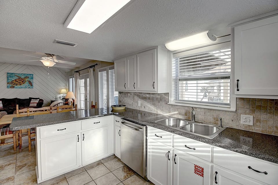 Your fully-equipped kitchen features granite countertops, stainless appliances, and ample prep space for creating memorable meals during your stay.