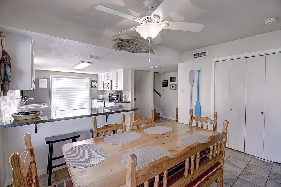 Gather around your spacious dining table for memorable meals while the ocean breeze flows through your bright, open-concept living space.