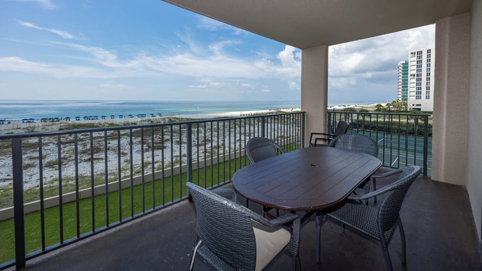 Enjoy meals at the patio table while taking in the calming views of the water and beach from your balcony