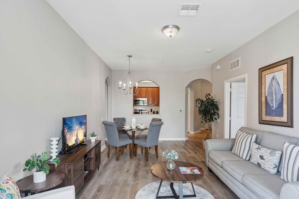 Cosmopolitan Comfort: Unwind in our living area, featuring a sleek kitchen and a dining space, designed for both stylish entertaining and everyday living