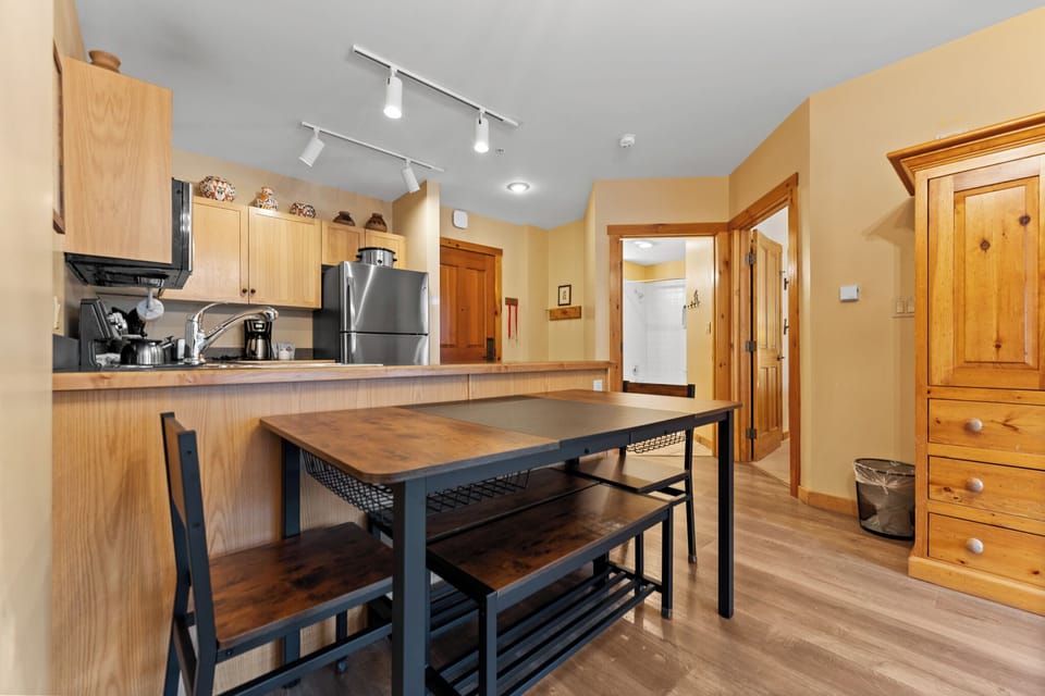 Your kitchen awaits with warm wood cabinets, modern appliances, and a rustic island perfect for cooking meals together.