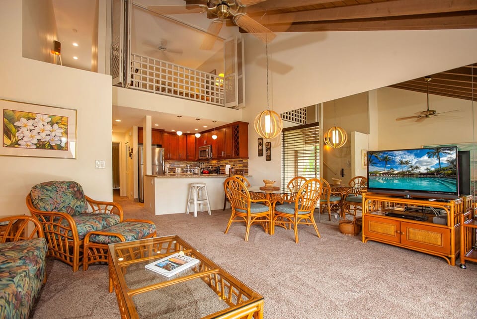 Settle into your breezy island retreat, where soaring ceilings and tropical furnishings invite you to unwind. The open-concept design flows from kitchen to dining to living, perfect for your Hawaiian getaway.