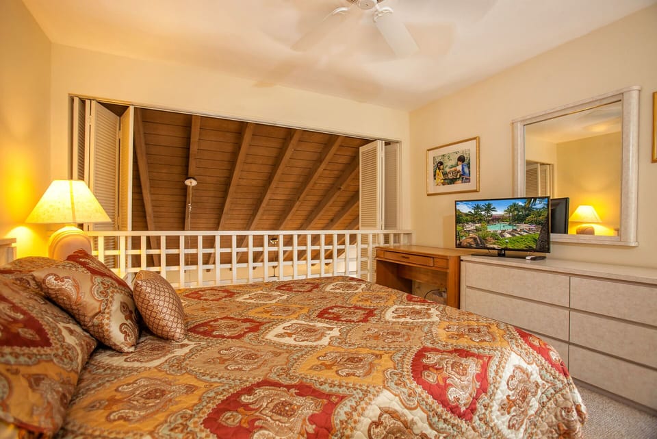 Curl up in your cozy bedroom with warm wood ceilings, soft lighting, and tropical views on the TV—perfect for unwinding after a sun-filled day.