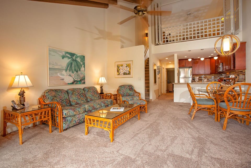 Step into your tropical-inspired open-concept retreat, where vaulted ceilings, warm wood accents, and coastal décor invite you to unwind and truly feel at home.