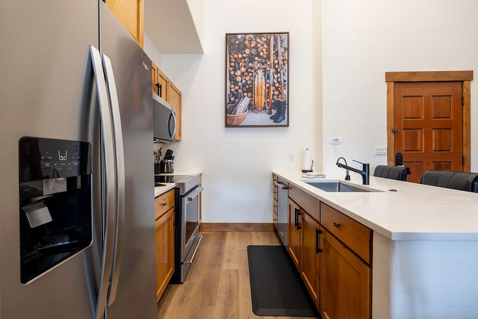 Your modern kitchen features warm wood cabinetry, stainless steel appliances, and sleek countertops for preparing memorable meals together.
