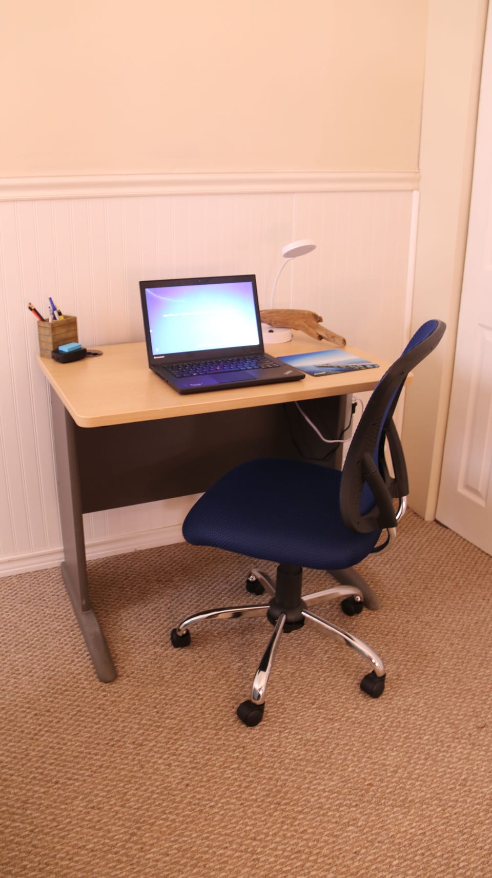 Desk with USB charger and power strip.