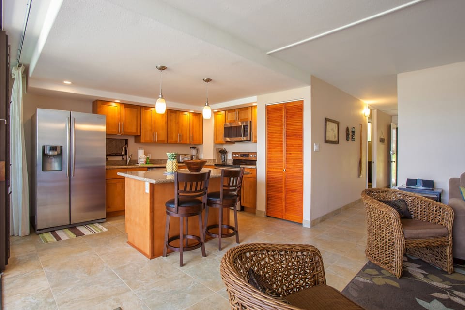 Your open kitchen and living area blend seamlessly, offering granite counters, stainless appliances, and a cozy breakfast bar—perfect for preparing meals and unwinding together.