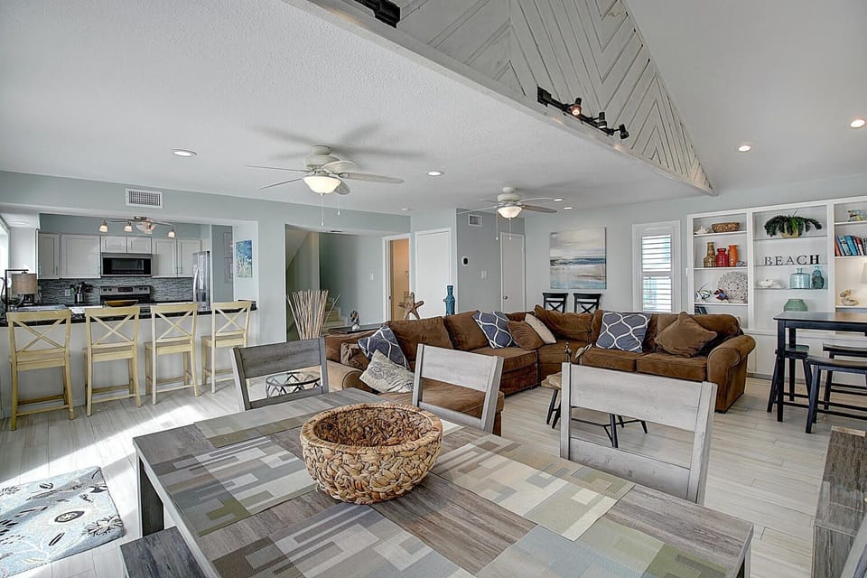 Your bright coastal retreat offers an open living space where you can unwind on plush sofas while ocean breezes flow through.