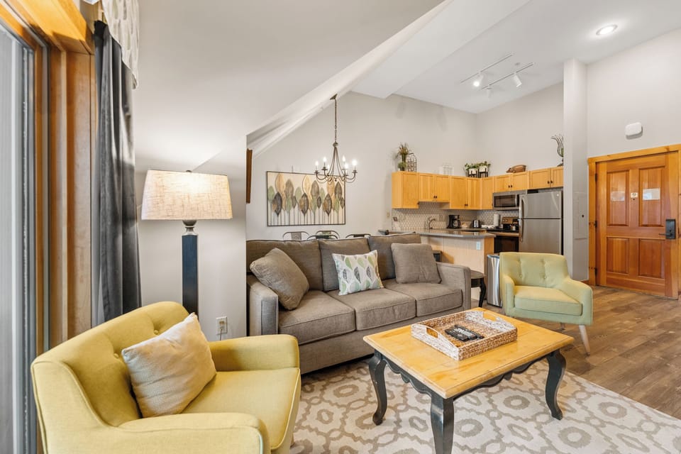 Unwind in your spacious living area with plush seating and open kitchen, perfect for gathering with loved ones.