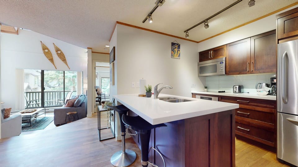 A central hub for gathering, the kitchen blends seamlessly with the dining and living areas.