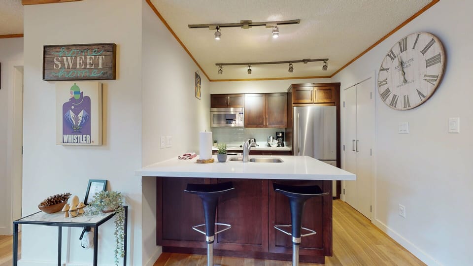 The fully equipped kitchen boasts stainless steel appliances and plenty of counter space.