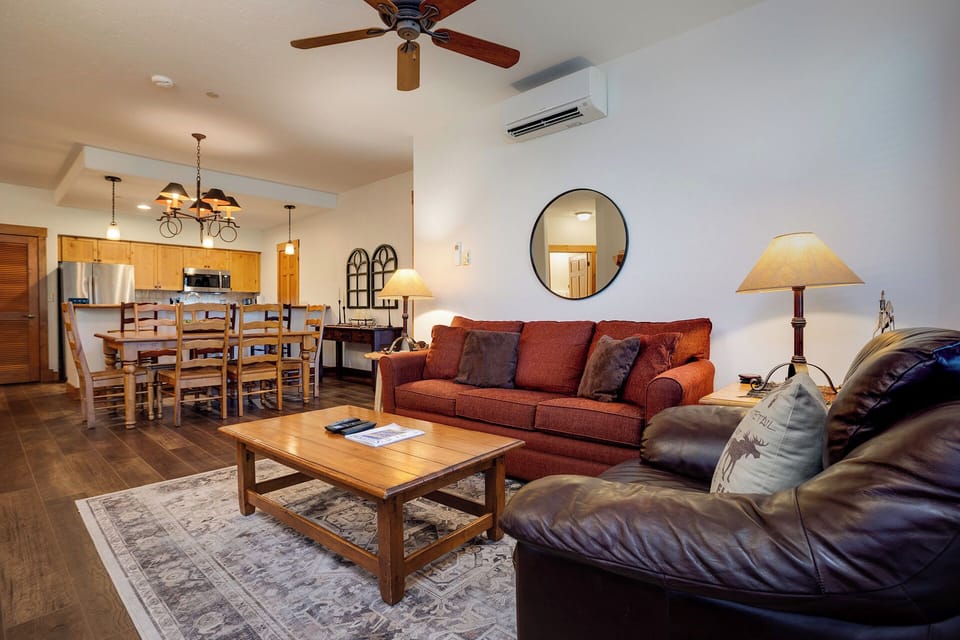 Relax in your spacious open-concept living space with plush seating, modern kitchen, and climate control for your comfort.