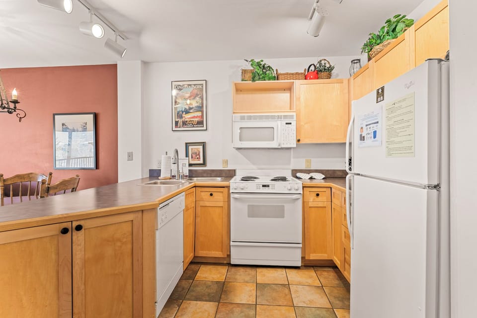 Your fully equipped kitchen awaits with warm wood cabinetry, modern appliances, and everything needed to create memorable meals during your stay.