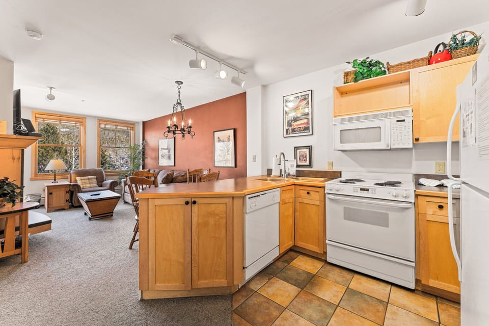 Your fully equipped kitchen flows seamlessly into the dining and living area, creating a warm, open space for cooking and gathering.