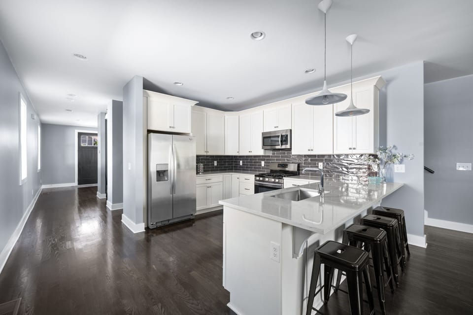 Quartz counters provide ample space for cooking and counter seating for meals. 