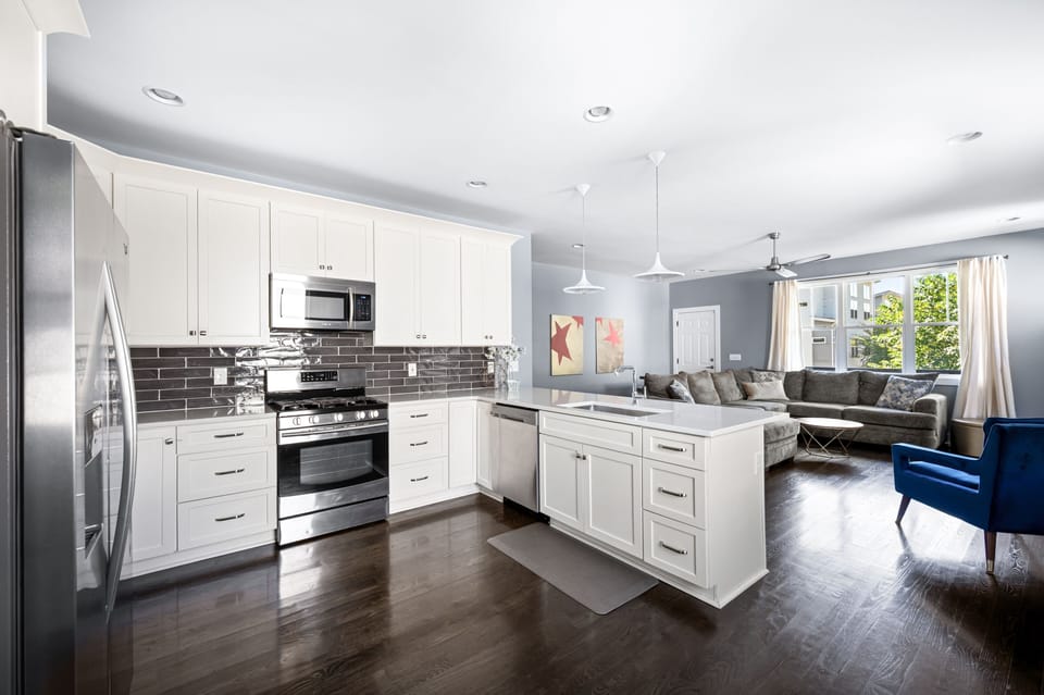 Kitchen boasts stainless steel appliances, gas range, dishwasher & microwave.