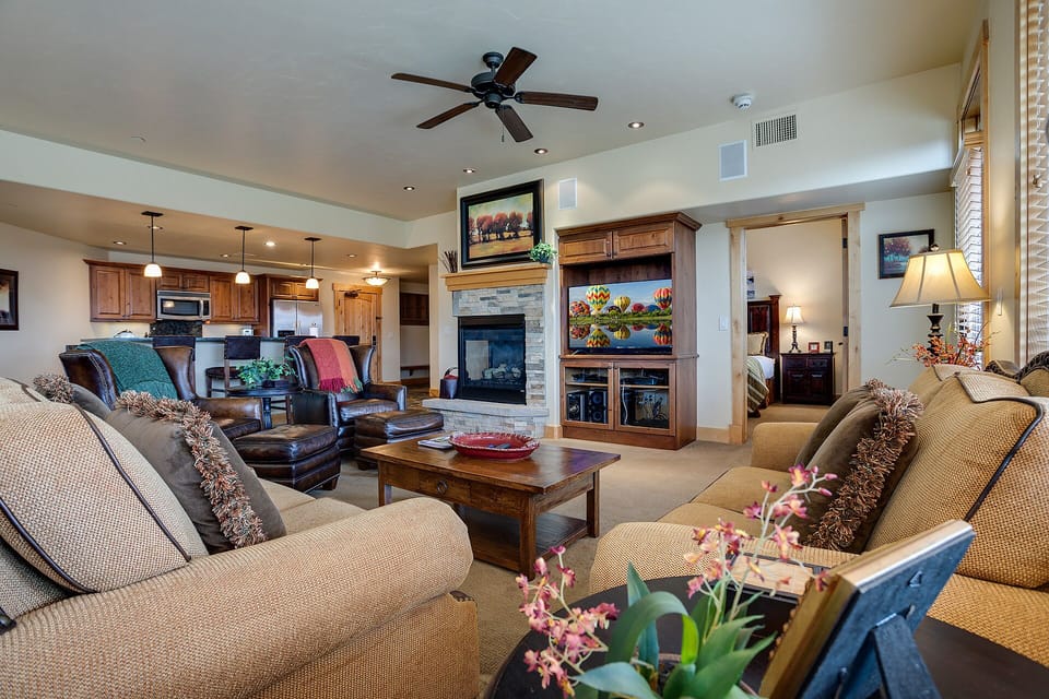Relax in your spacious living room with cozy seating, warm fireplace, and entertainment center for perfect evenings.