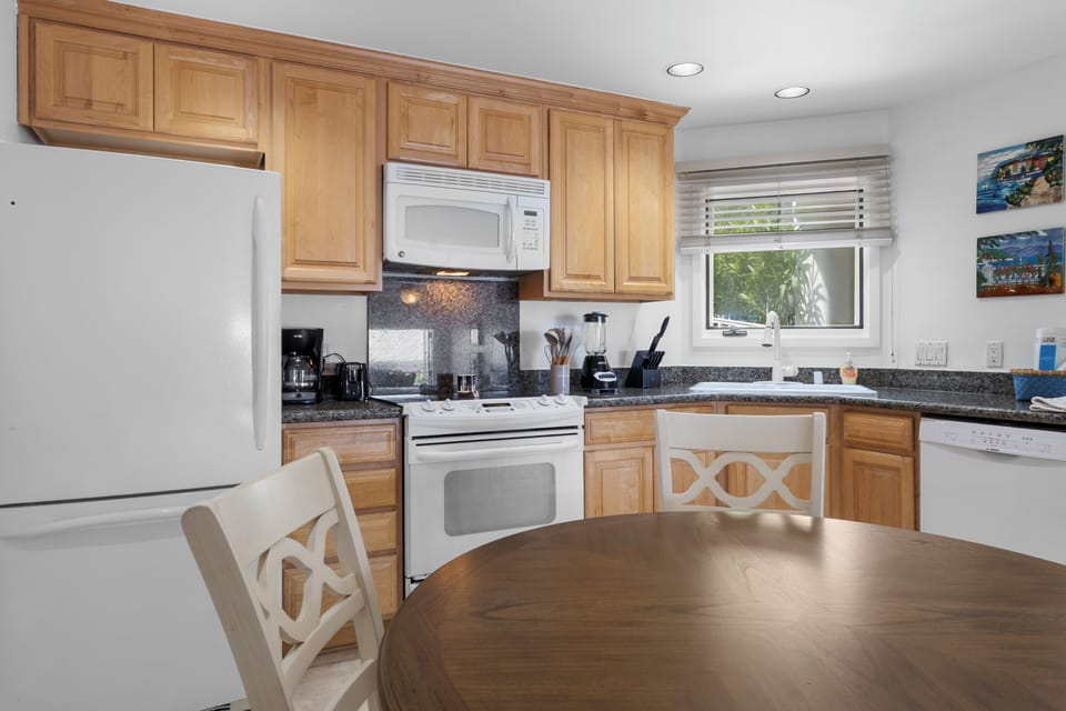 Your fully-equipped kitchen features warm wood cabinets, granite counters, and everything you need to prepare meals during your stay.
