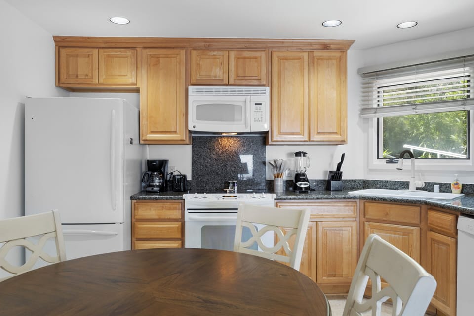 Your fully equipped kitchen features granite counters, wood cabinets, and all appliances for preparing memorable meals together.
