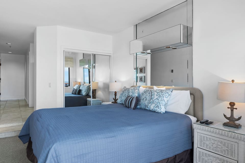 Drift off to sleep in this serene coastal bedroom where soft blue linens and nautical touches create your perfect seaside retreat.