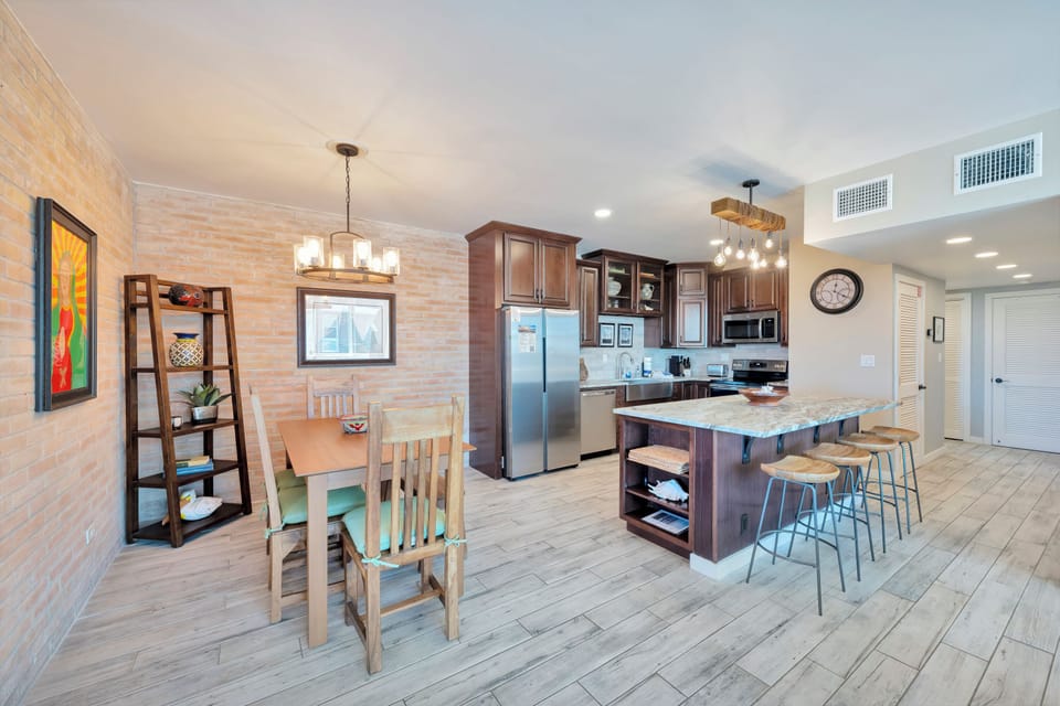 Your open-concept kitchen and dining area welcomes you with granite countertops, warm wood finishes, and modern appliances perfect for family gatherings.
