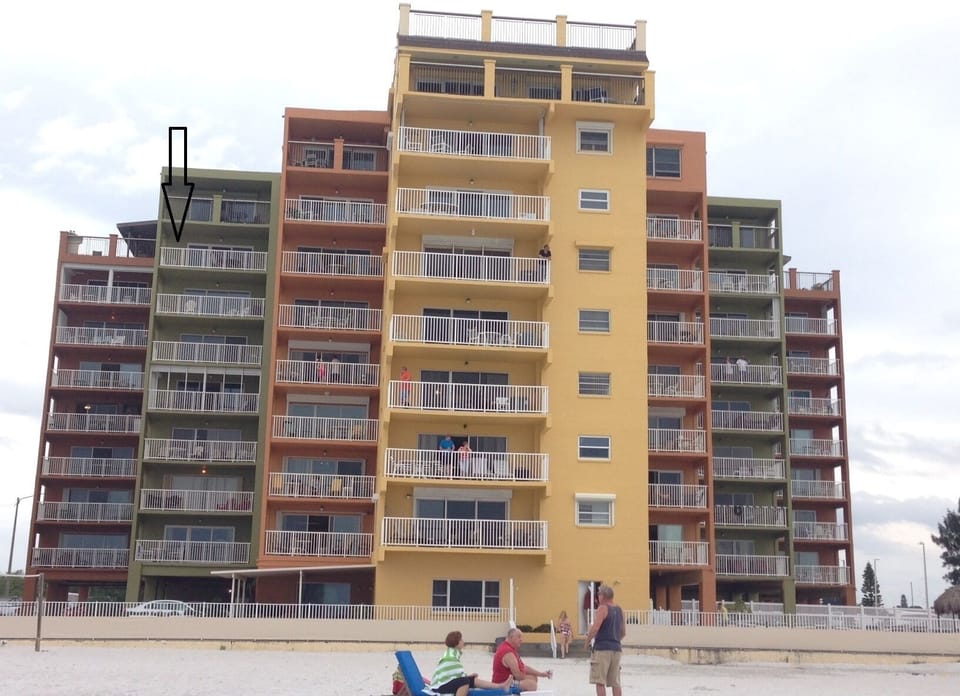 Building view from the sand - our unit faces the beach - direct beachfront pointed in black arrow - unit 706.  Freshly painted exterior of building!!