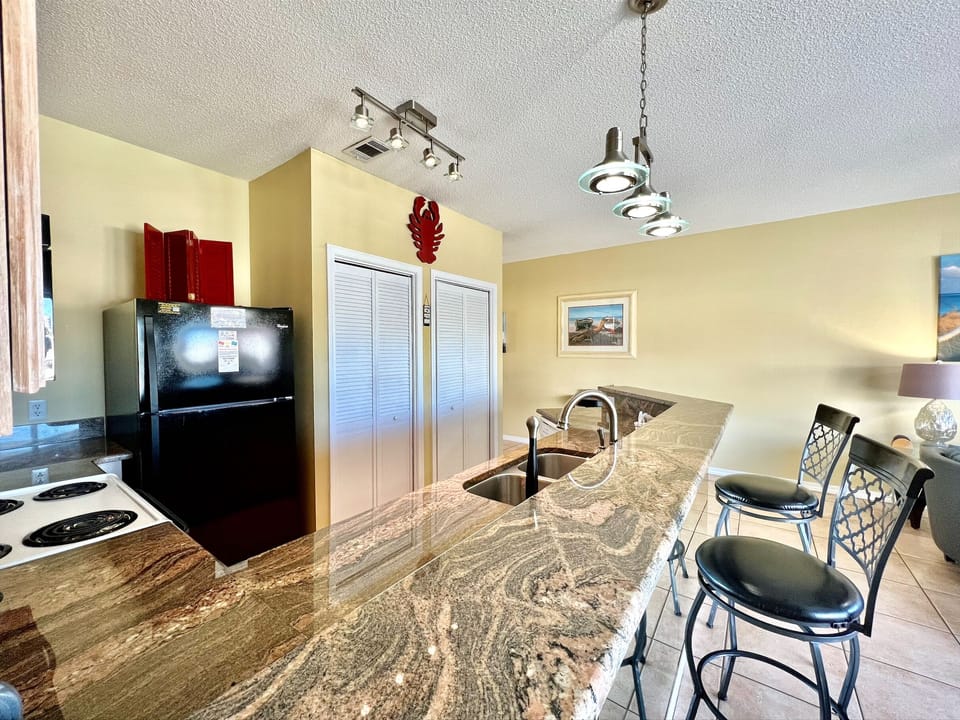 Your fully equipped kitchen features stunning granite countertops, modern appliances, and a breakfast bar where you can savor morning coffee while planning your day.