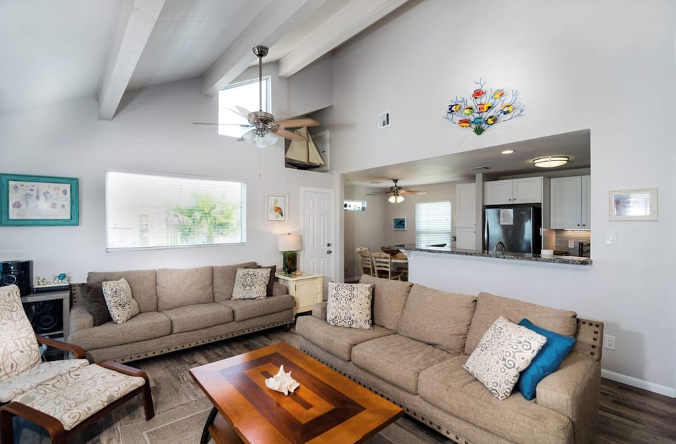 Relax in your spacious living room with soaring ceilings and modern comfort, flowing seamlessly into the open kitchen for effortless gatherings.