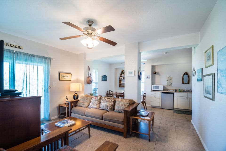 Relax in your bright, coastal-themed living space where ocean breezes flow through and comfortable seating invites you to unwind after beach days.