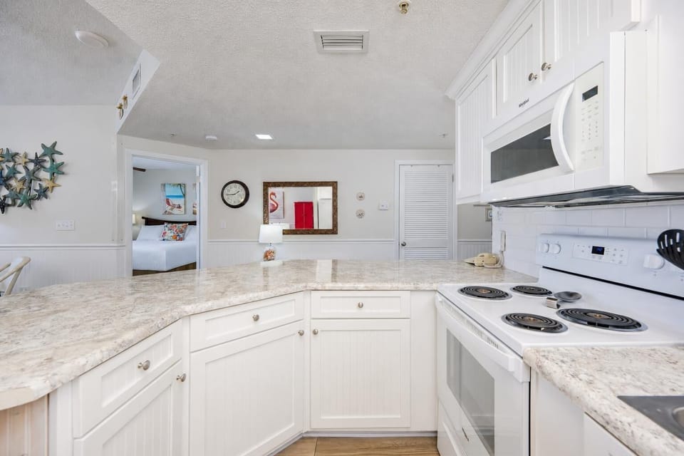 Smooth granite counters guide your hands while you prepare meals in the bright kitchen area