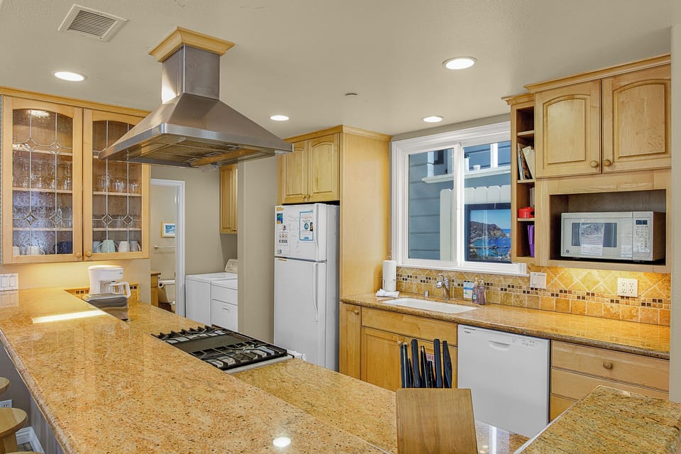Your spacious kitchen features granite counters, premium appliances, and warm wood cabinets perfect for preparing memorable meals together.