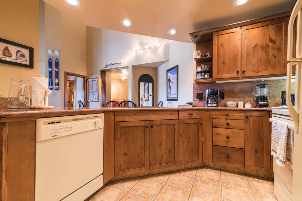 Your spacious kitchen features warm wood cabinets, granite counters, and modern appliances for memorable mountain cooking.